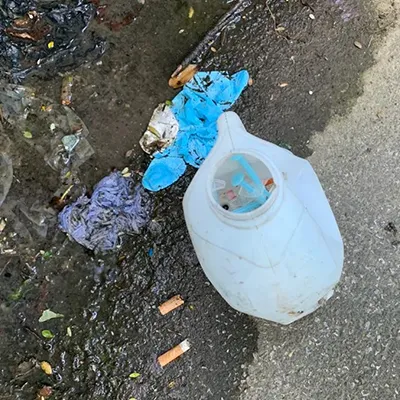 a white fire hydrant sitting on the side of a road