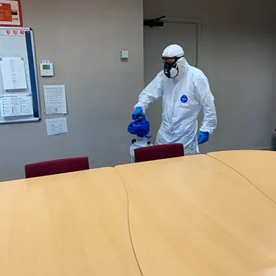 a man wearing a protective suit and gloves