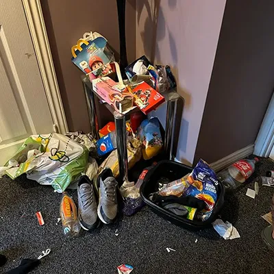 a pile of trash sitting on the floor next to a door