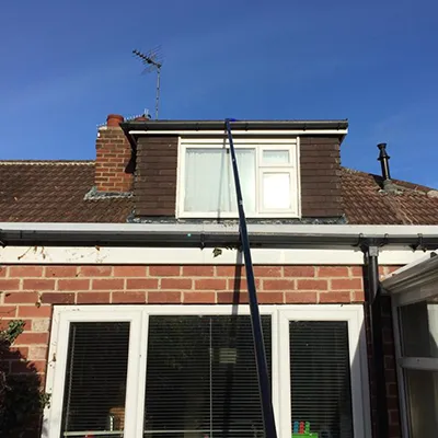 a house with a roof that has a weathervane attached to it