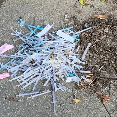 a pile of broken toothbrushes on the ground